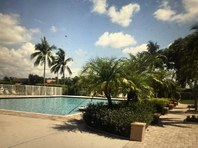 community pool featuring fence