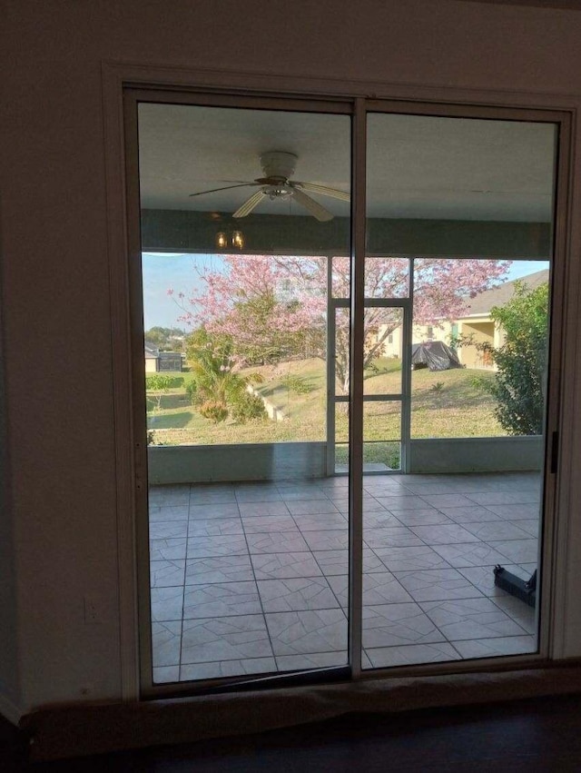 doorway to outside with a ceiling fan