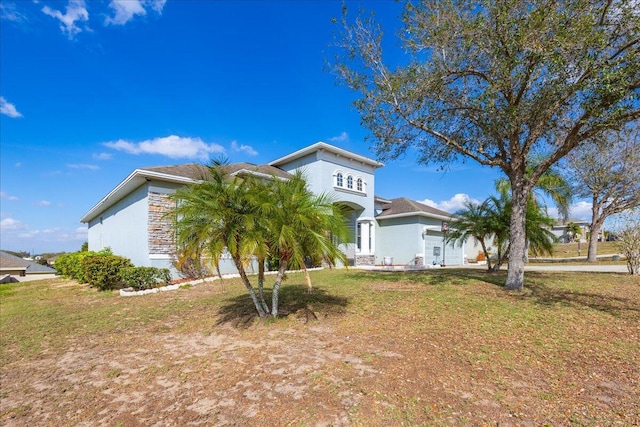 view of front of home featuring a garage and a front lawn