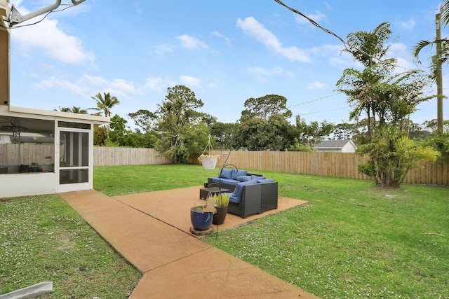 view of yard featuring a patio area, outdoor lounge area, a fenced backyard, and a sunroom