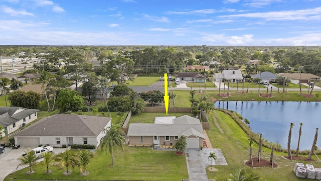 drone / aerial view with a water view and a residential view