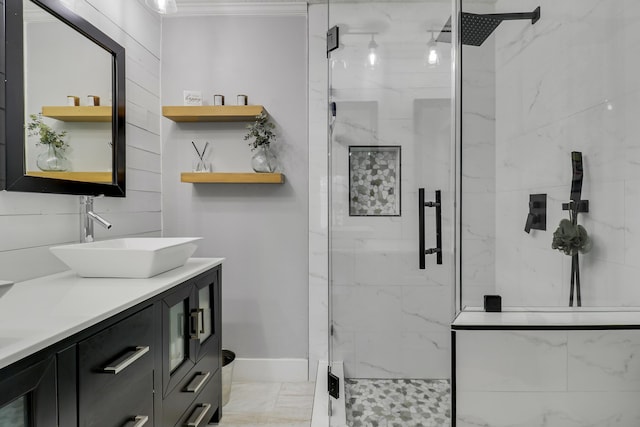 full bathroom with marble finish floor, baseboards, vanity, and a marble finish shower