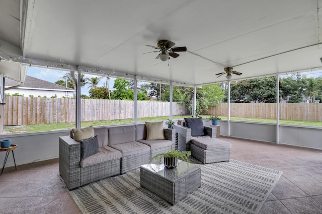 sunroom featuring a ceiling fan