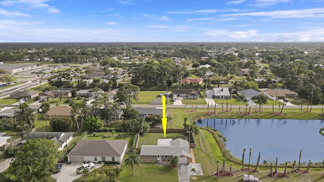 drone / aerial view with a water view and a residential view