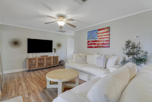 living area featuring ornamental molding, wood finished floors, visible vents, and a ceiling fan