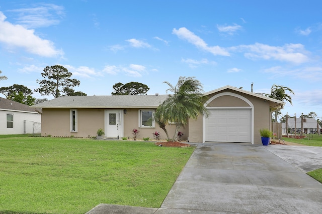 single story home featuring an attached garage, fence, driveway, stucco siding, and a front lawn