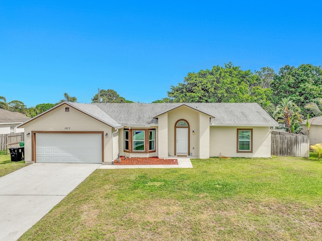 1973 SW Davis St, Port Saint Lucie, FL 34953 - view of front facade featuring stucco siding, concrete driveway, a front yard, fence, and a garage