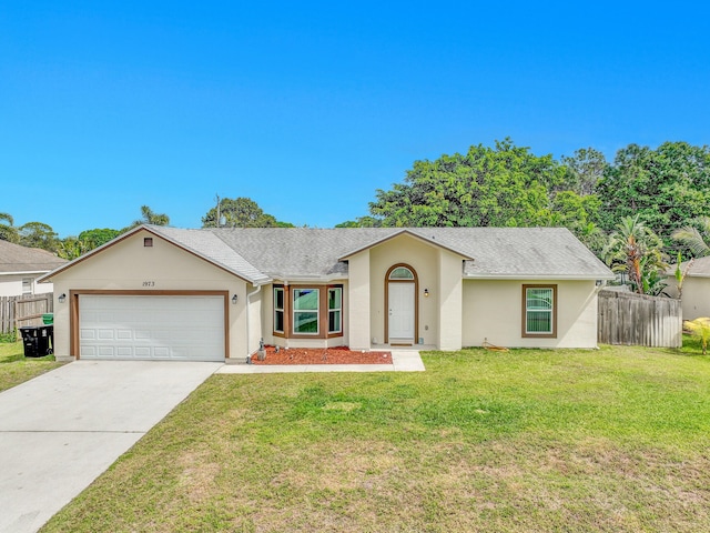 view of front facade featuring stucco siding, concrete driveway, a front yard, fence, and a garage