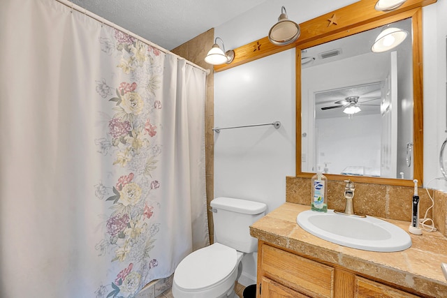 bathroom with visible vents, backsplash, toilet, vanity, and a textured ceiling