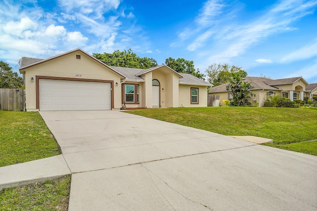 ranch-style home with a front lawn, fence, an attached garage, and stucco siding