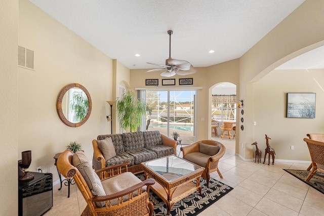 living area featuring light tile patterned floors, baseboards, visible vents, and recessed lighting