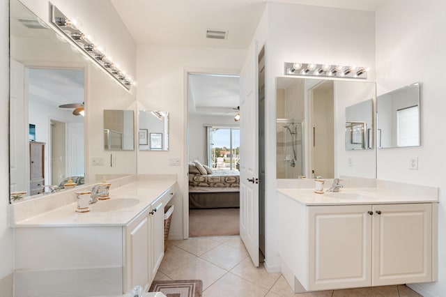 bathroom with a sink, a stall shower, connected bathroom, and visible vents