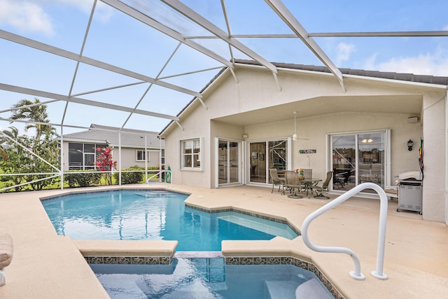 view of swimming pool with a pool with connected hot tub, glass enclosure, a patio, and grilling area