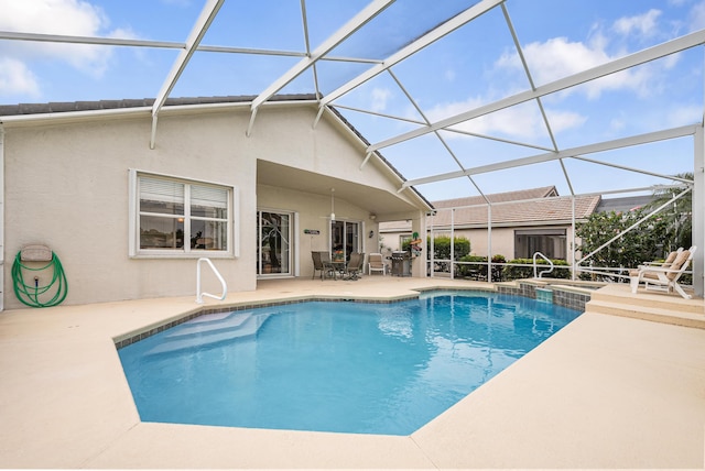 view of pool featuring a lanai, a patio area, and a pool with connected hot tub