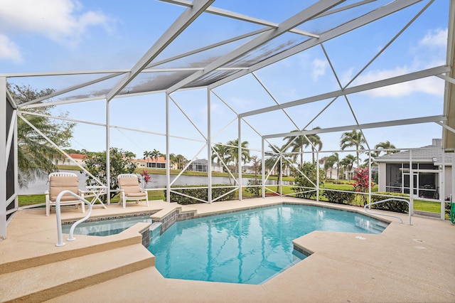 view of swimming pool featuring a patio area, a pool with connected hot tub, and glass enclosure