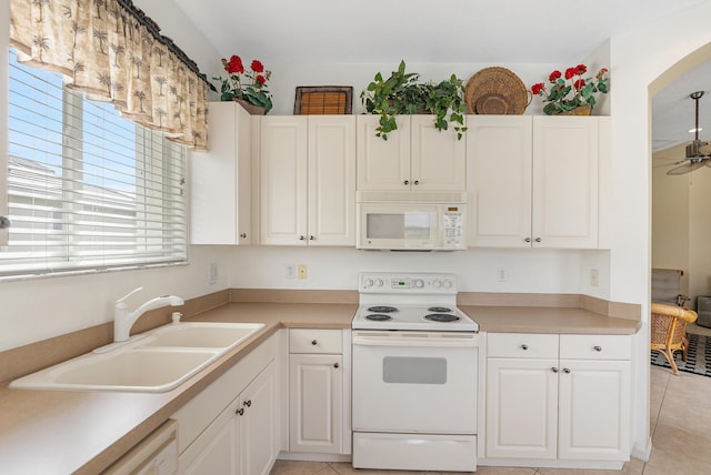 kitchen with light countertops, white appliances, a sink, and a ceiling fan