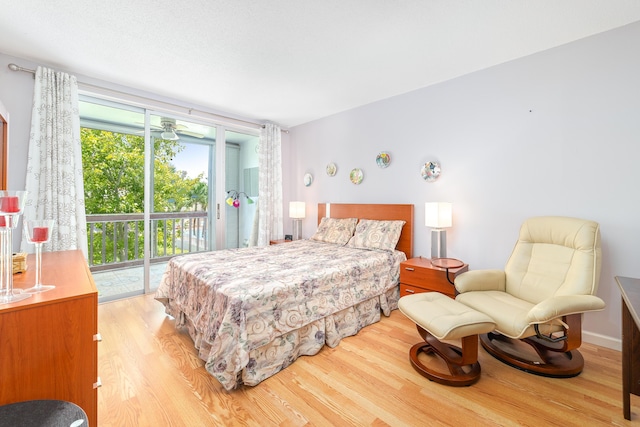 bedroom featuring light wood-type flooring and access to outside