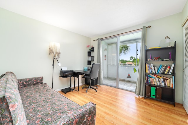 home office featuring baseboards and wood finished floors