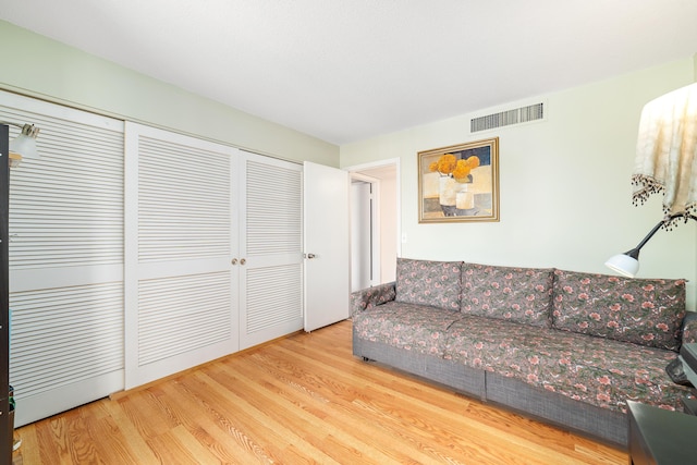 living room featuring visible vents and wood finished floors