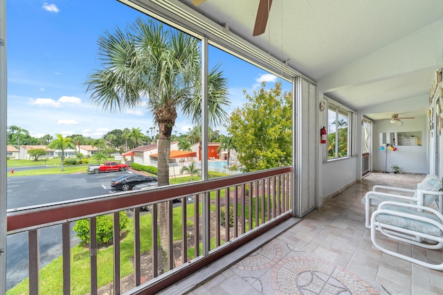 balcony featuring a sunroom and a residential view