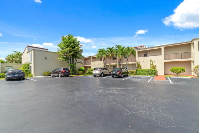 uncovered parking lot featuring a residential view