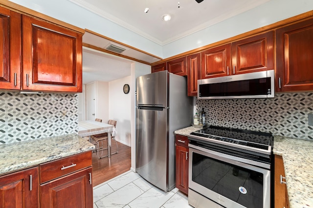 kitchen featuring marble finish floor, ornamental molding, appliances with stainless steel finishes, light stone countertops, and tasteful backsplash