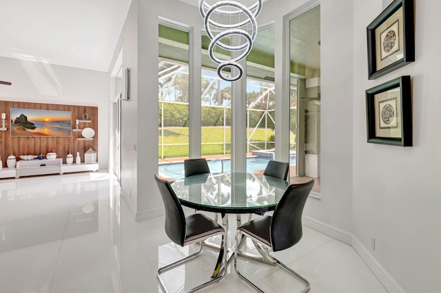 dining room featuring an inviting chandelier, baseboards, and a wealth of natural light