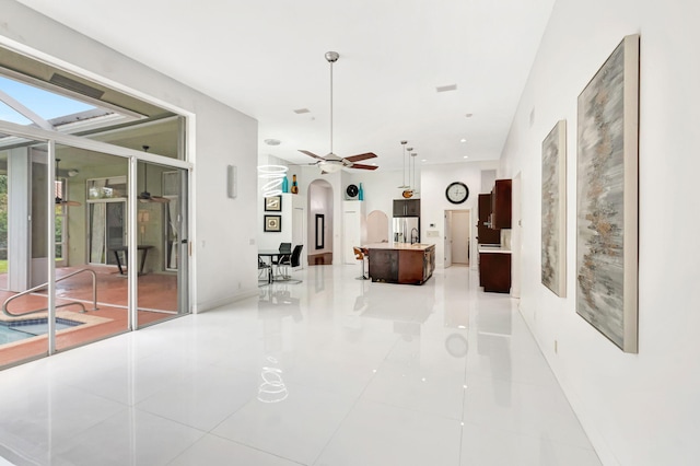 19035 Cypress Crik Ct, Boca Raton, FL 33498 - corridor featuring arched walkways and light tile patterned flooring