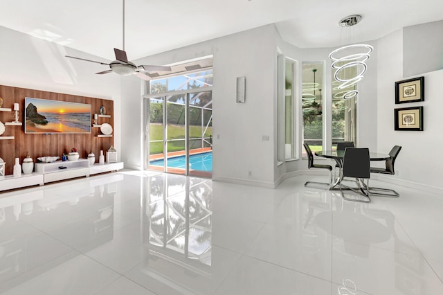 interior space featuring ceiling fan and baseboards