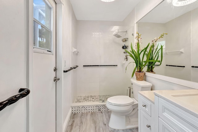 bathroom featuring a stall shower, vanity, and toilet