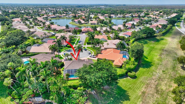 birds eye view of property with a water view and a residential view