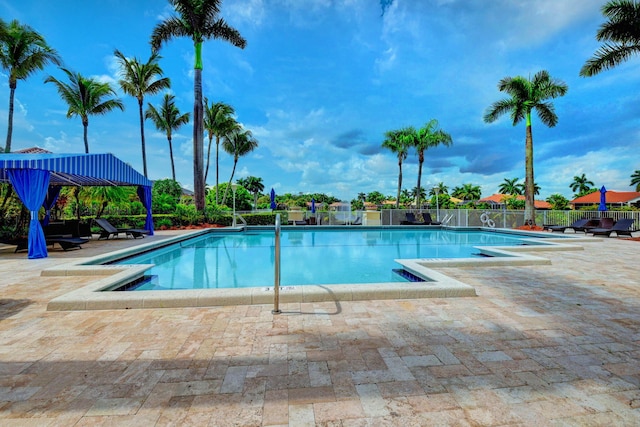 pool featuring a patio and fence