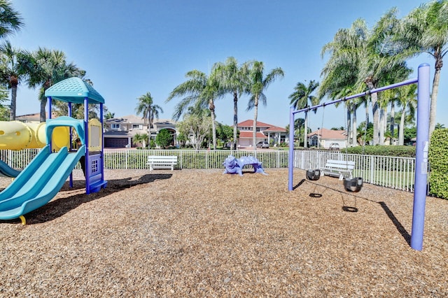 community jungle gym with a residential view and fence