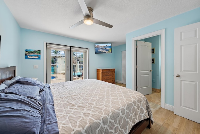 bedroom with french doors, access to outside, ceiling fan, a textured ceiling, and light wood-type flooring