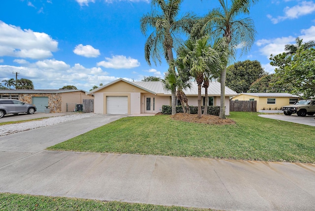 ranch-style house featuring a garage, fence, driveway, stucco siding, and a front lawn