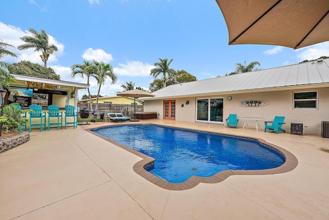 view of pool with a patio, french doors, fence, and a fenced in pool