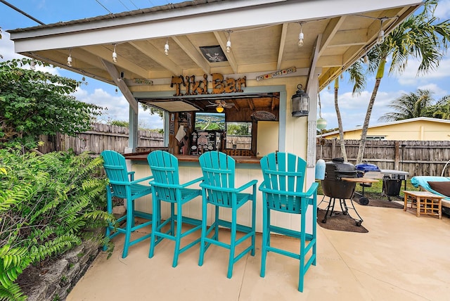 view of patio / terrace with fence and outdoor dry bar