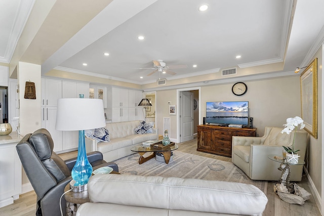 living area featuring recessed lighting, visible vents, crown molding, and light wood finished floors