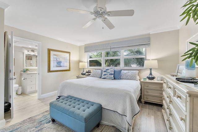 bedroom with ornamental molding, ceiling fan, ensuite bath, light wood-type flooring, and baseboards