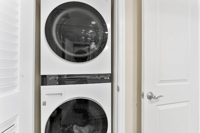 laundry room featuring laundry area and stacked washing maching and dryer