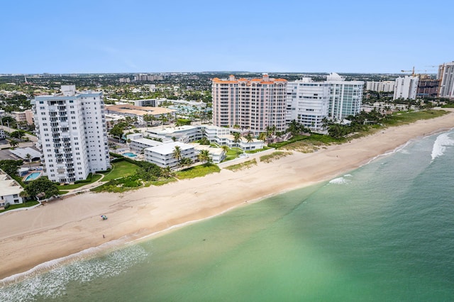 birds eye view of property featuring a beach view, a water view, and a city view