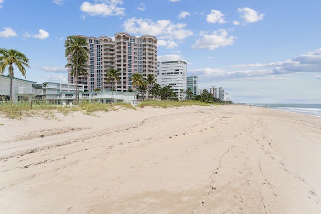 view of property featuring a water view and a view of the beach