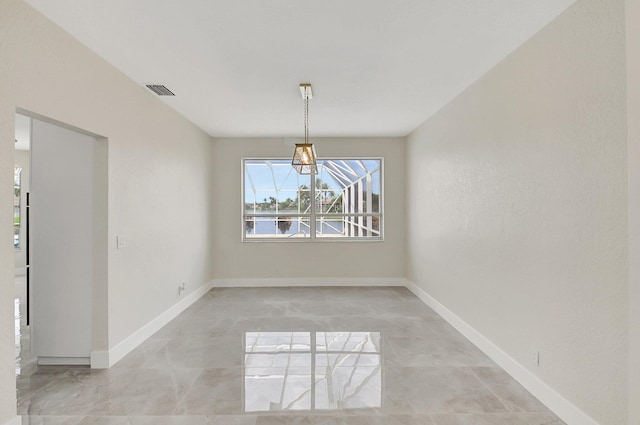 unfurnished dining area featuring visible vents and baseboards