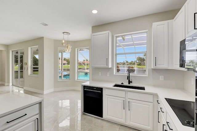 kitchen with black appliances, a sink, a wealth of natural light, and white cabinetry