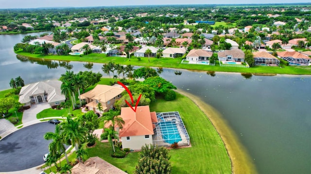 drone / aerial view featuring a residential view and a water view