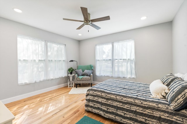 bedroom featuring ceiling fan, baseboards, wood finished floors, and recessed lighting