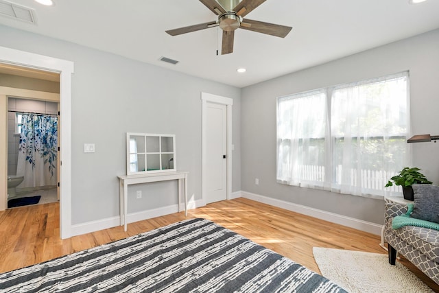 sitting room featuring baseboards, visible vents, and wood finished floors