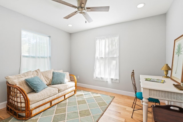 living area with plenty of natural light, baseboards, wood finished floors, and recessed lighting