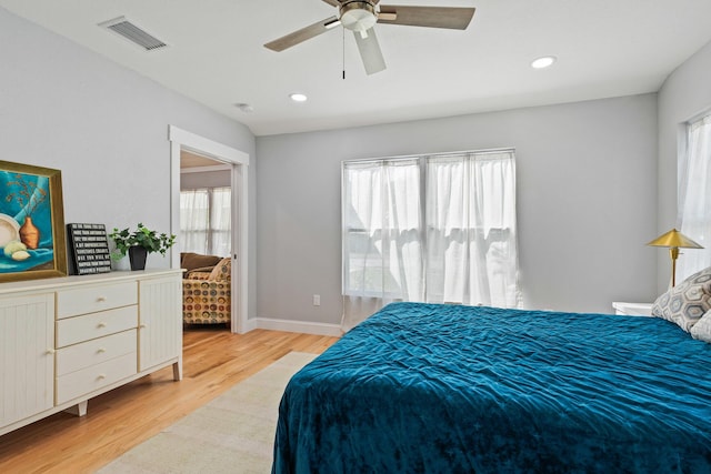 bedroom with light wood finished floors, recessed lighting, visible vents, a ceiling fan, and baseboards