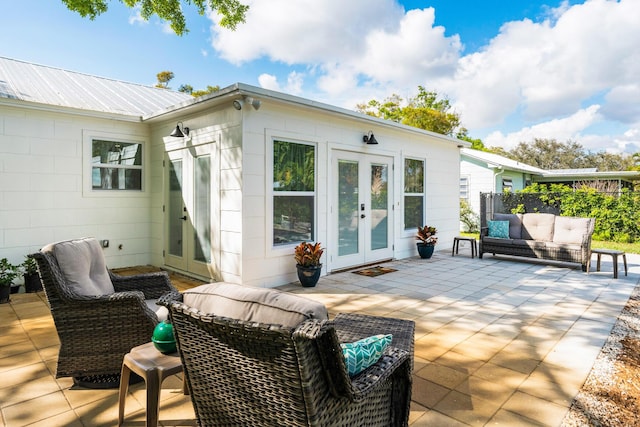 exterior space featuring metal roof, a patio, french doors, and outdoor lounge area